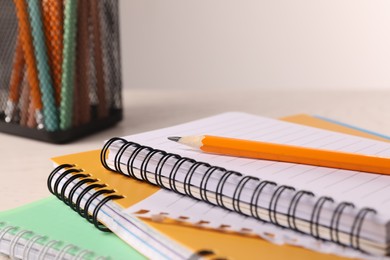 Photo of Closeup view of notebooks and pencil at workspace