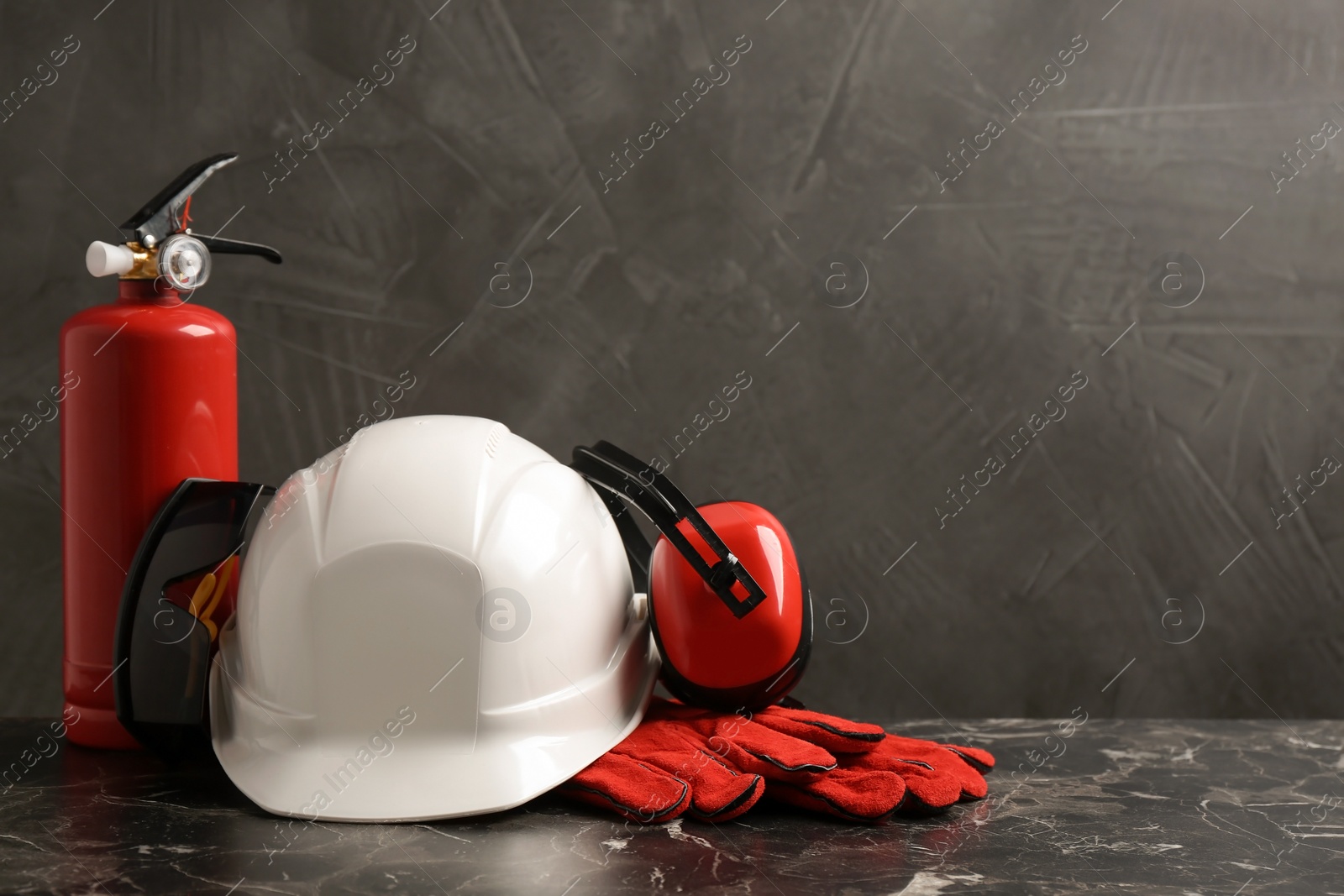 Photo of Composition with safety equipment on table against grey background. Space for text