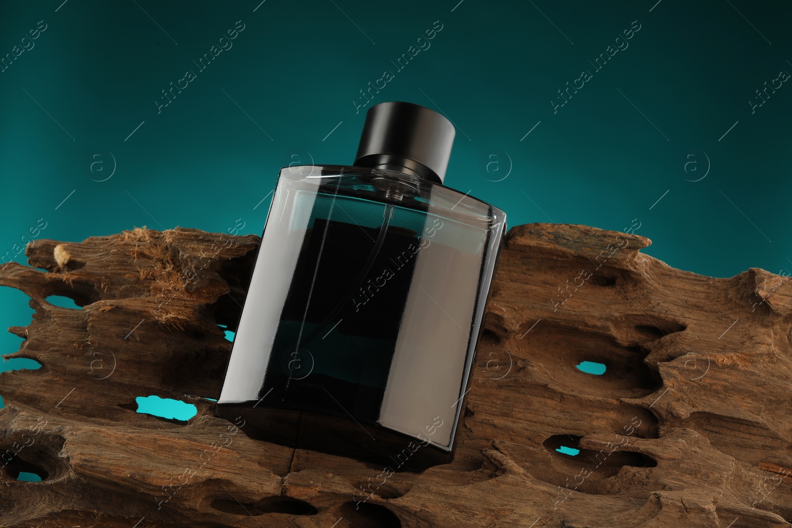 Photo of Luxury men`s perfume in bottle against color background