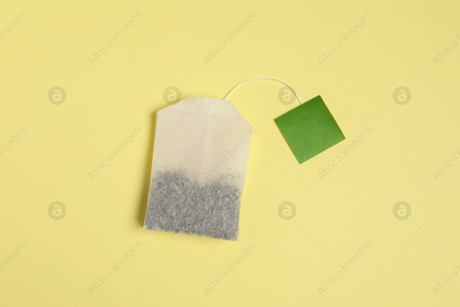 Photo of New tea bag with tab on beige background, top view