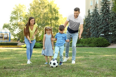 Happy family with children spending time together in green park on sunny day