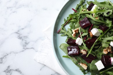 Fresh delicious beet salad on white marble table, top view. Space for text