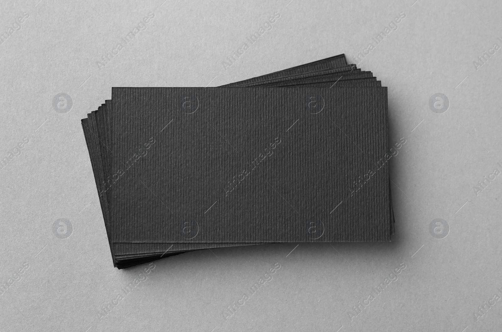 Photo of Blank black business cards on light background, top view. Mockup for design