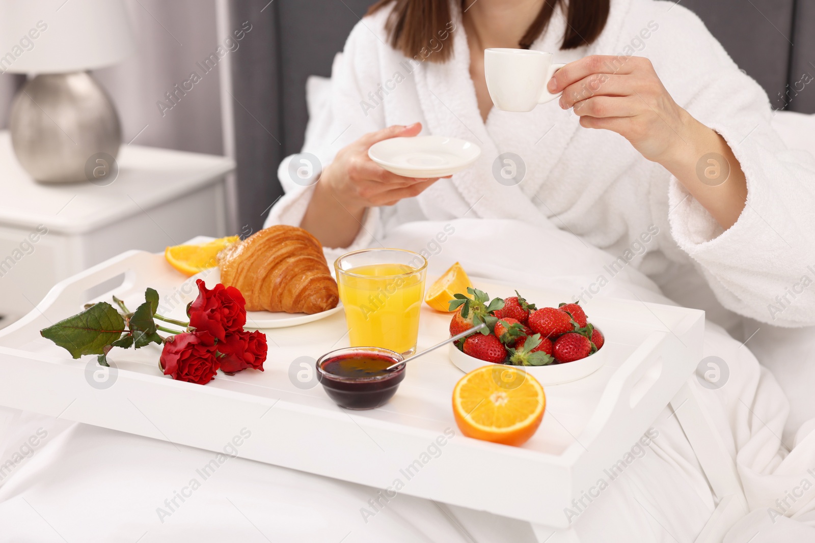 Photo of Woman having breakfast in bed at home, closeup