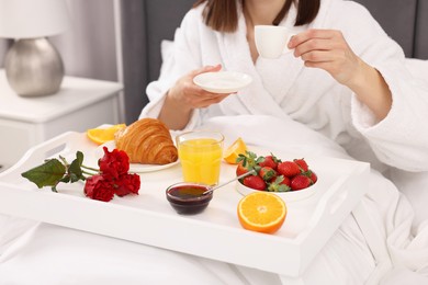 Photo of Woman having breakfast in bed at home, closeup