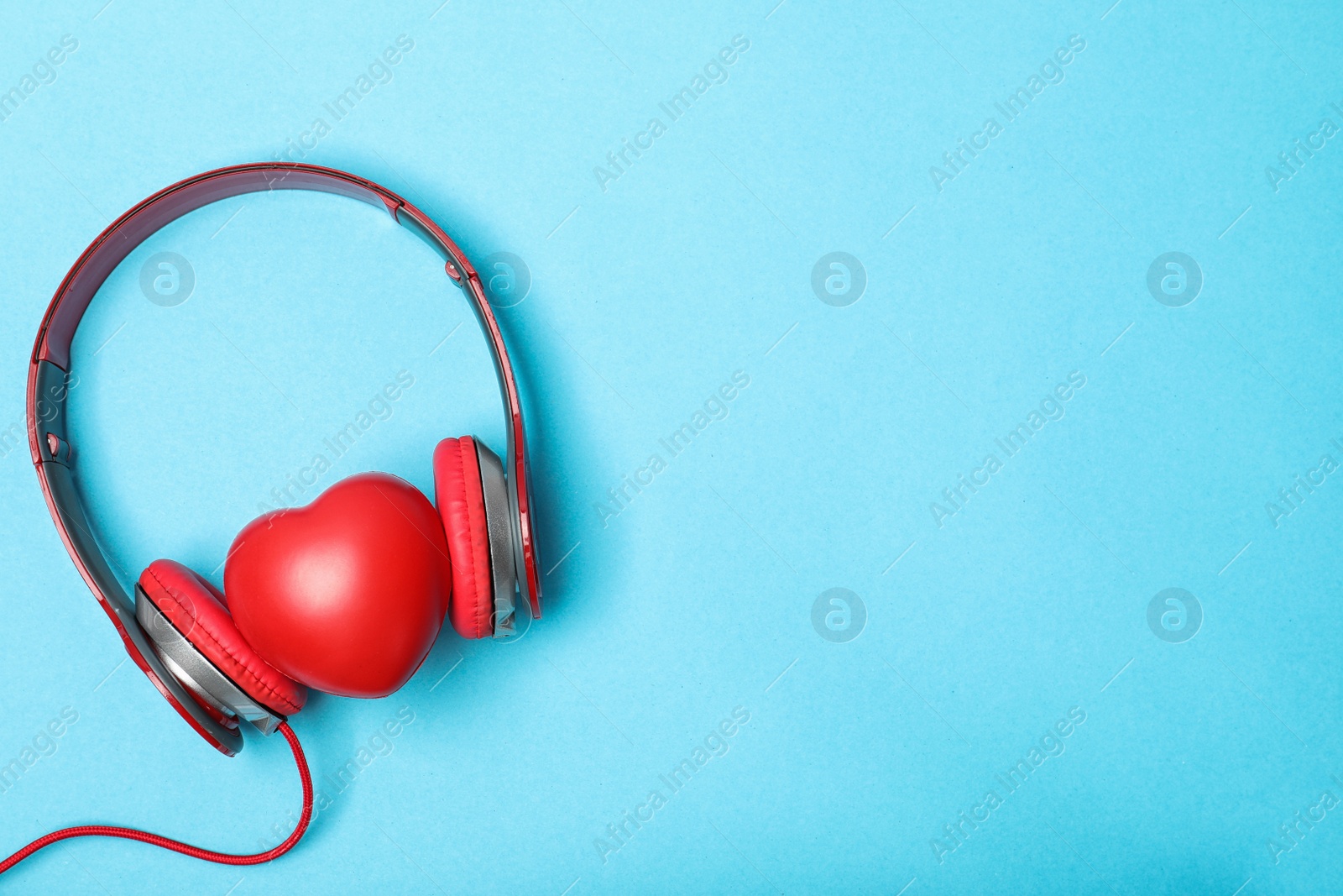 Photo of Flat lay composition with heart, headphones and space for text on color background