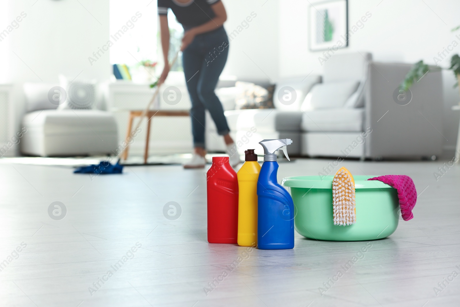 Photo of Basin and cleaning supplies on floor indoors