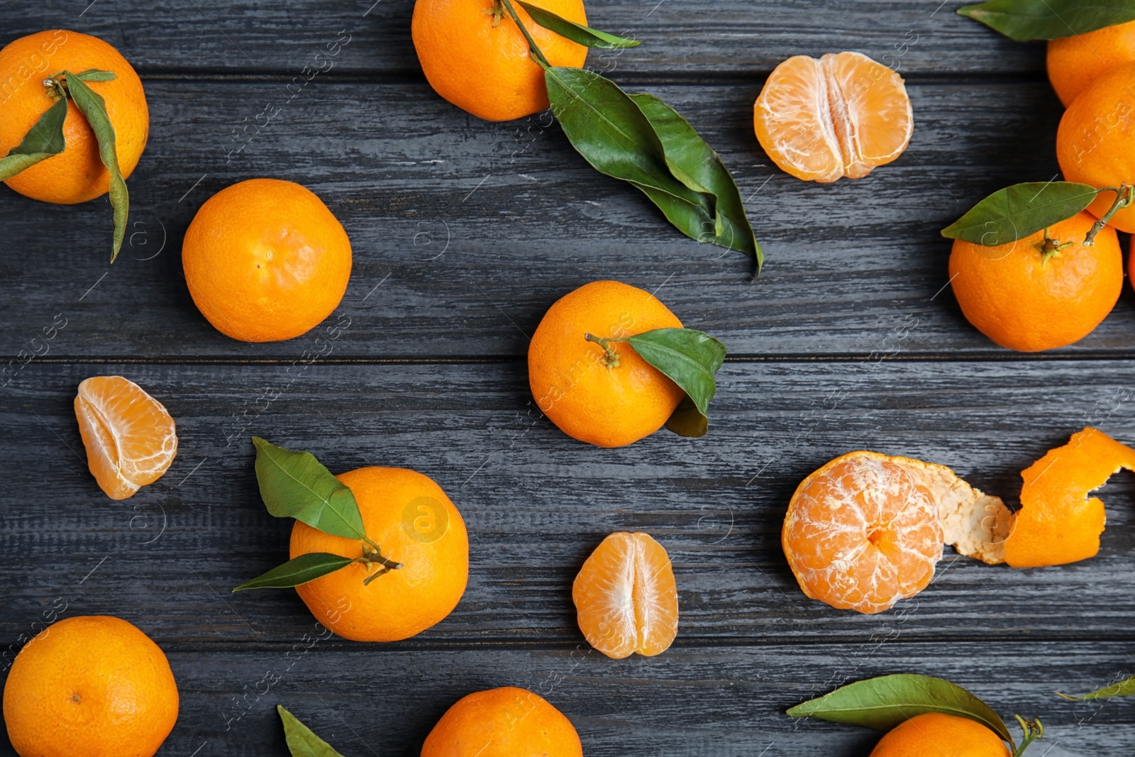 Photo of Fresh ripe tangerines on wooden background, top view