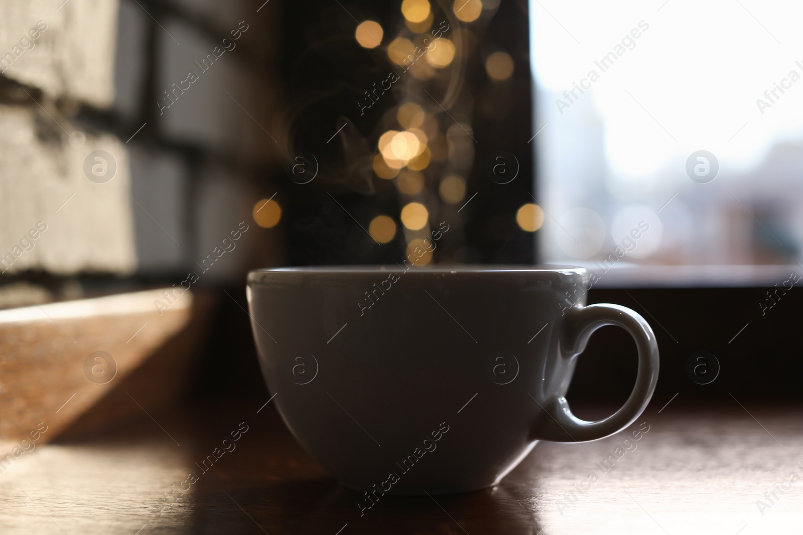 Photo of Delicious morning coffee near brick wall indoors