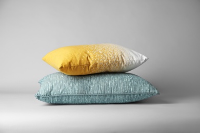 Photo of Soft decorative pillows on light background