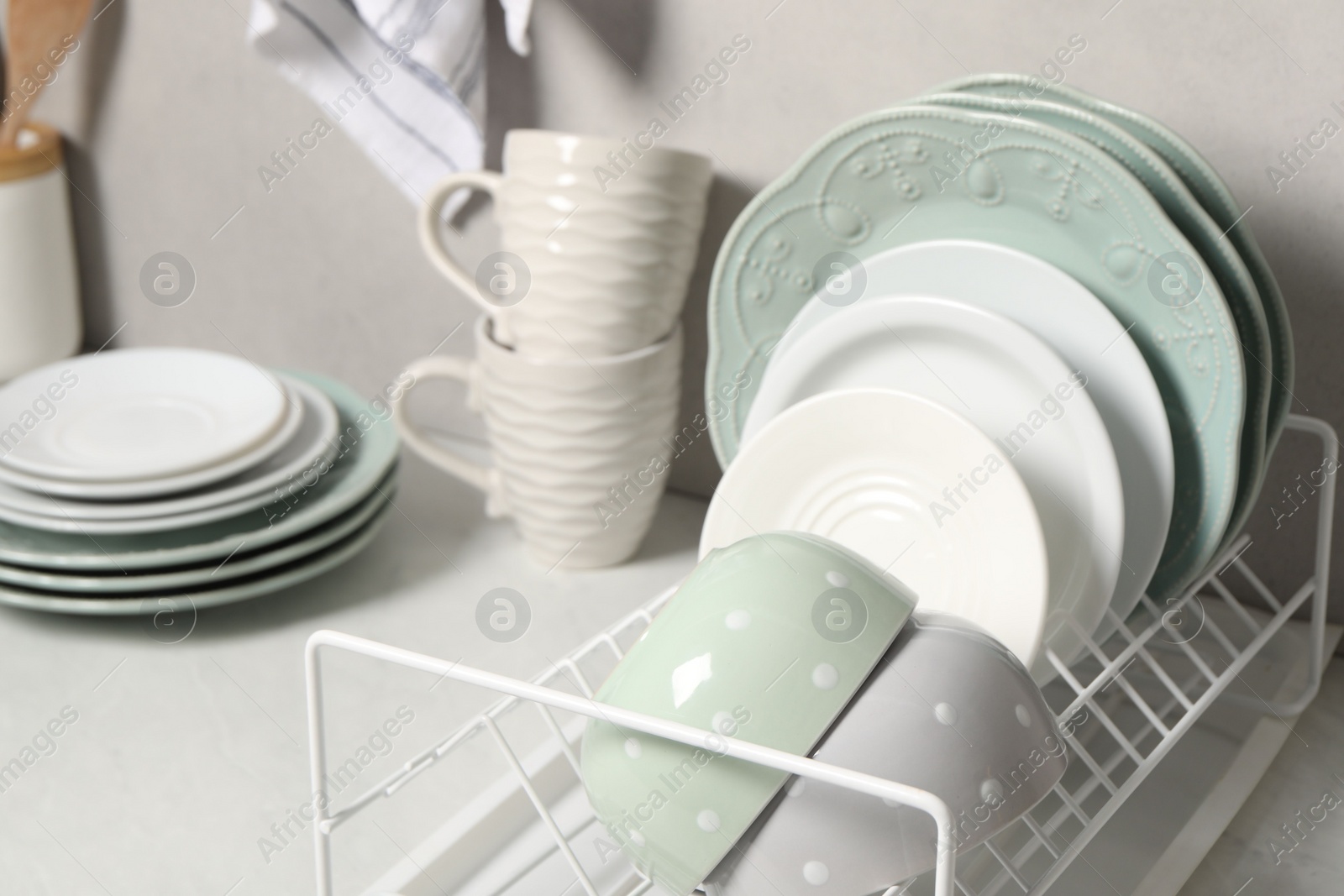 Photo of Many different clean dishware and cups on white table indoors