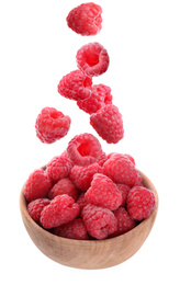 Image of Fresh ripe tasty raspberries falling into bowl on white background