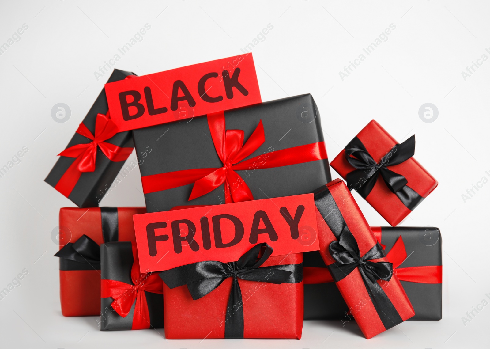 Photo of Many gift boxes and words Black Friday on white background