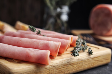 Photo of Slices of tasty ham on table, closeup