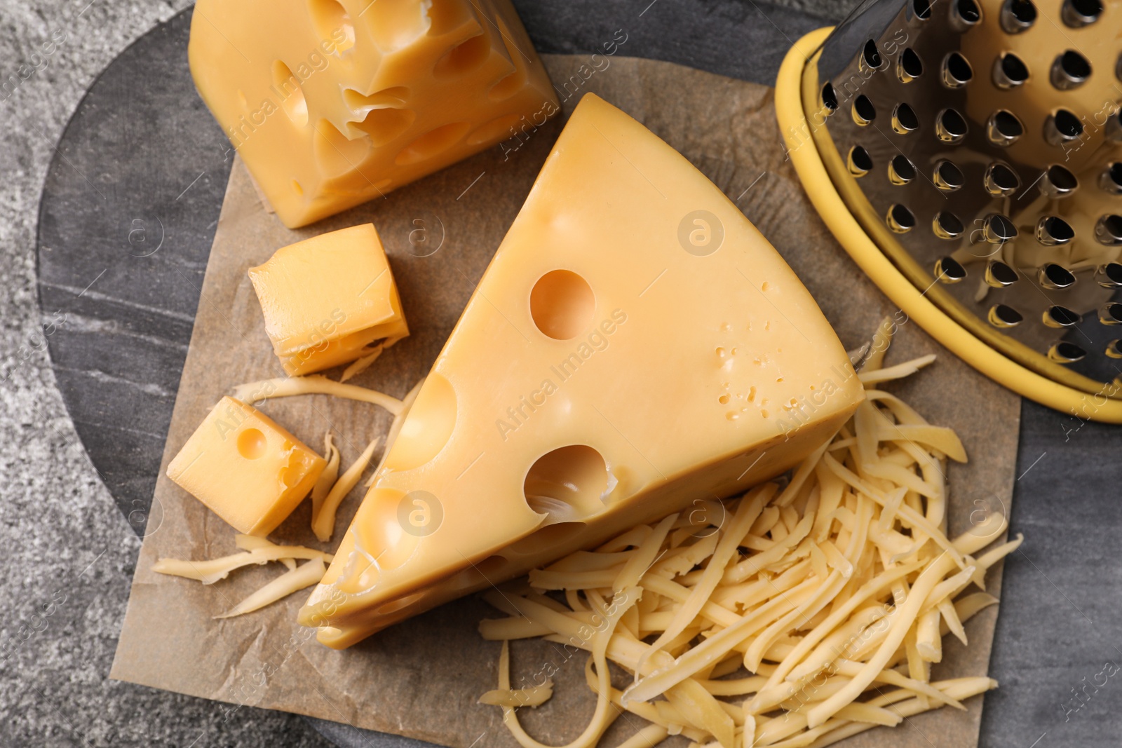 Photo of Tasty fresh cheese on grey table, top view