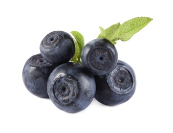 Delicious ripe bilberries and green leaves isolated on white