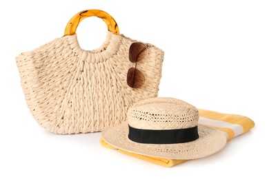 Photo of Stylish straw hat, beach bag, towel and sunglasses on white background