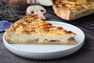 Delicious pie with mushrooms and cheese on grey table, closeup