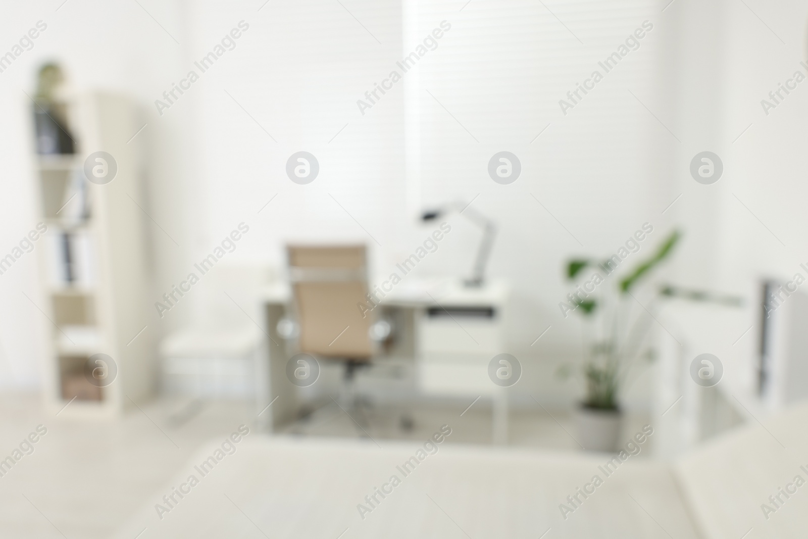 Photo of Blurred view of modern medical office with doctor's workplace in clinic