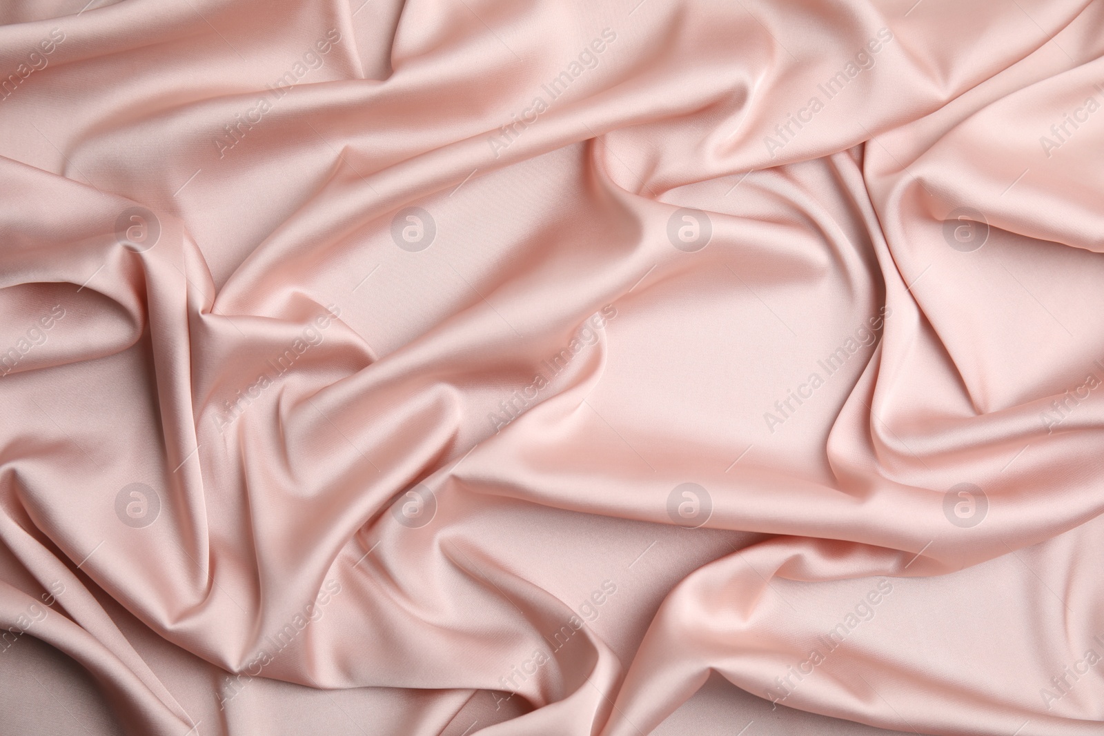 Photo of Texture of delicate pink silk as background, top view