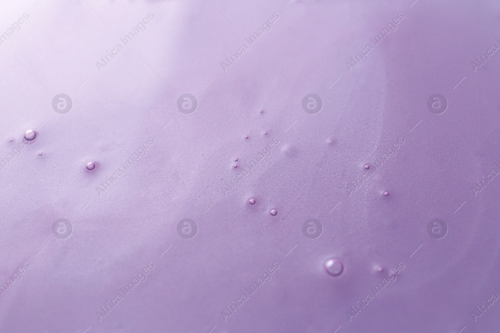 Photo of Texture of violet shower gel as background, closeup