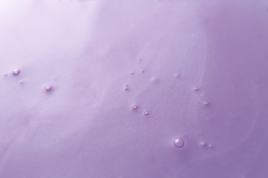 Photo of Texture of violet shower gel as background, closeup