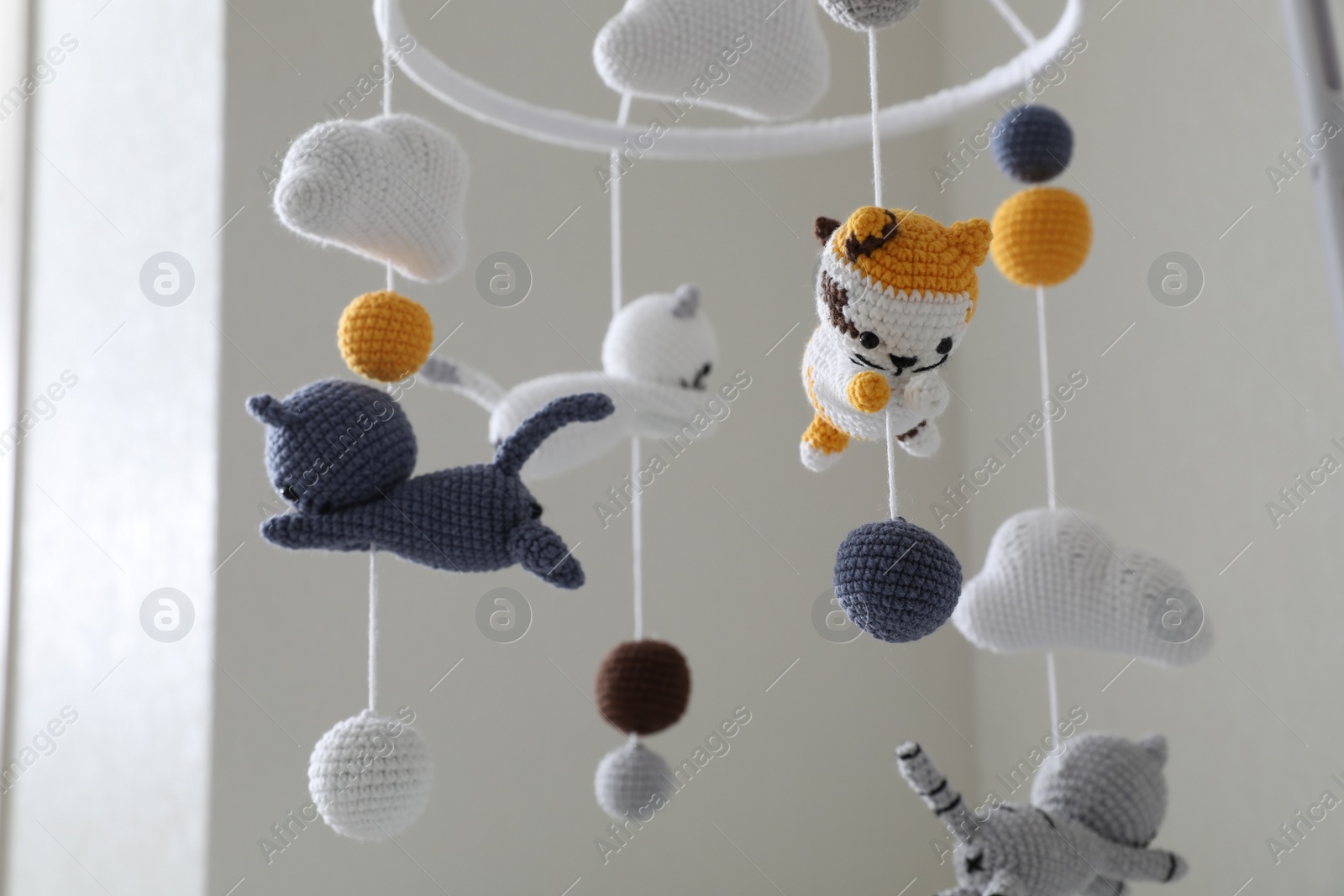 Photo of Modern baby crib mobile in children's room, closeup