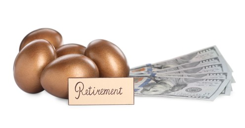 Photo of Many golden eggs, money and card with word Retirement on white background. Pension concept