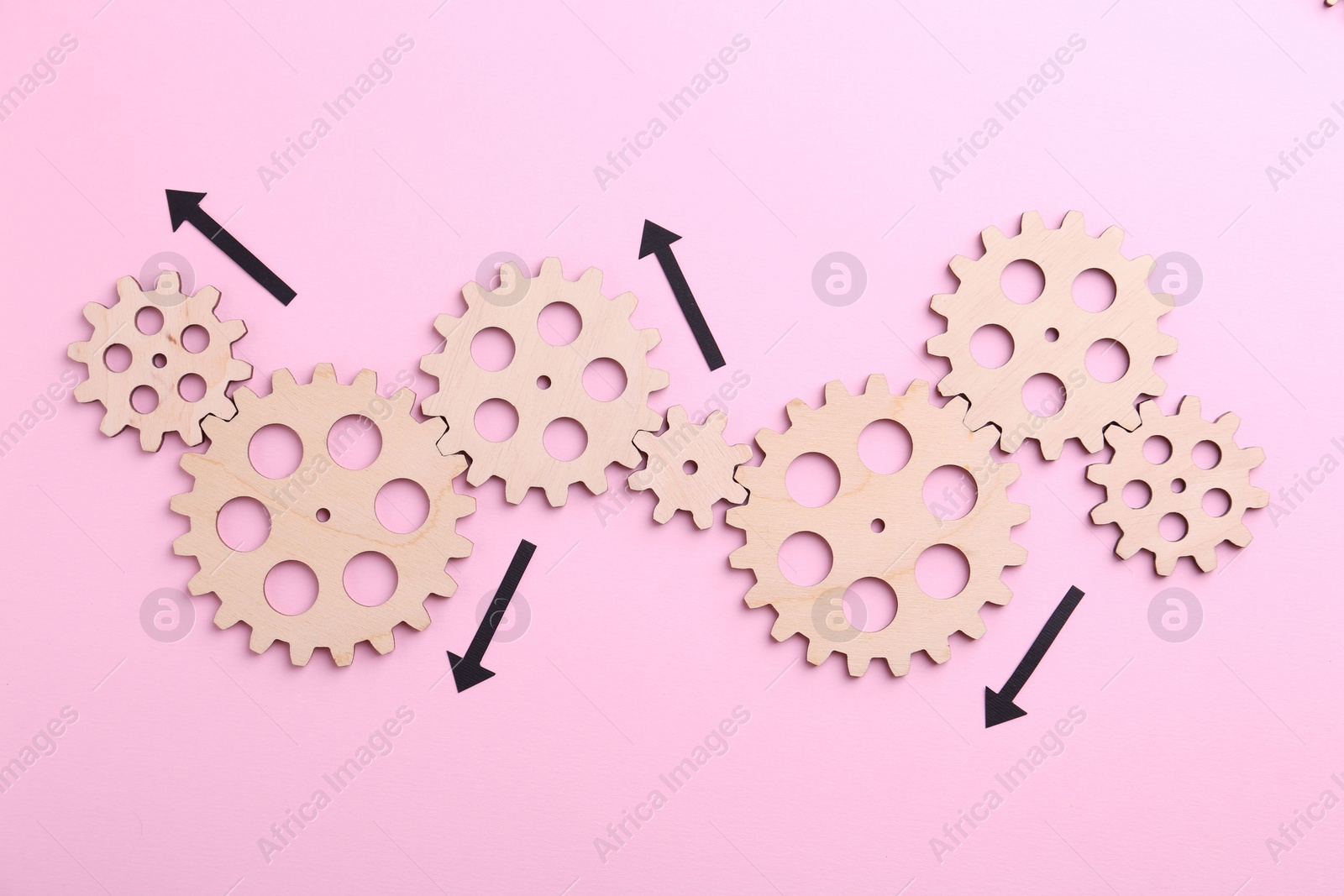 Photo of Business process organization and optimization. Scheme with wooden figures and arrows on pink background, top view