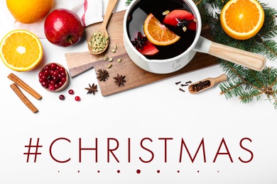 Hashtag Christmas, delicious mulled wine and ingredients on white background, flat lay