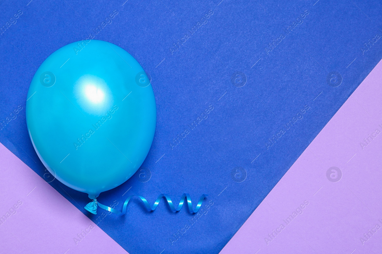 Photo of Bright balloon on colorful background, top view with space for text. Party time