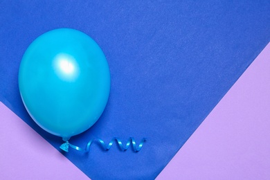 Bright balloon on colorful background, top view with space for text. Party time