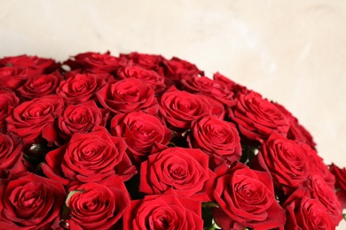 Photo of Luxury bouquet of fresh red roses on light background, closeup