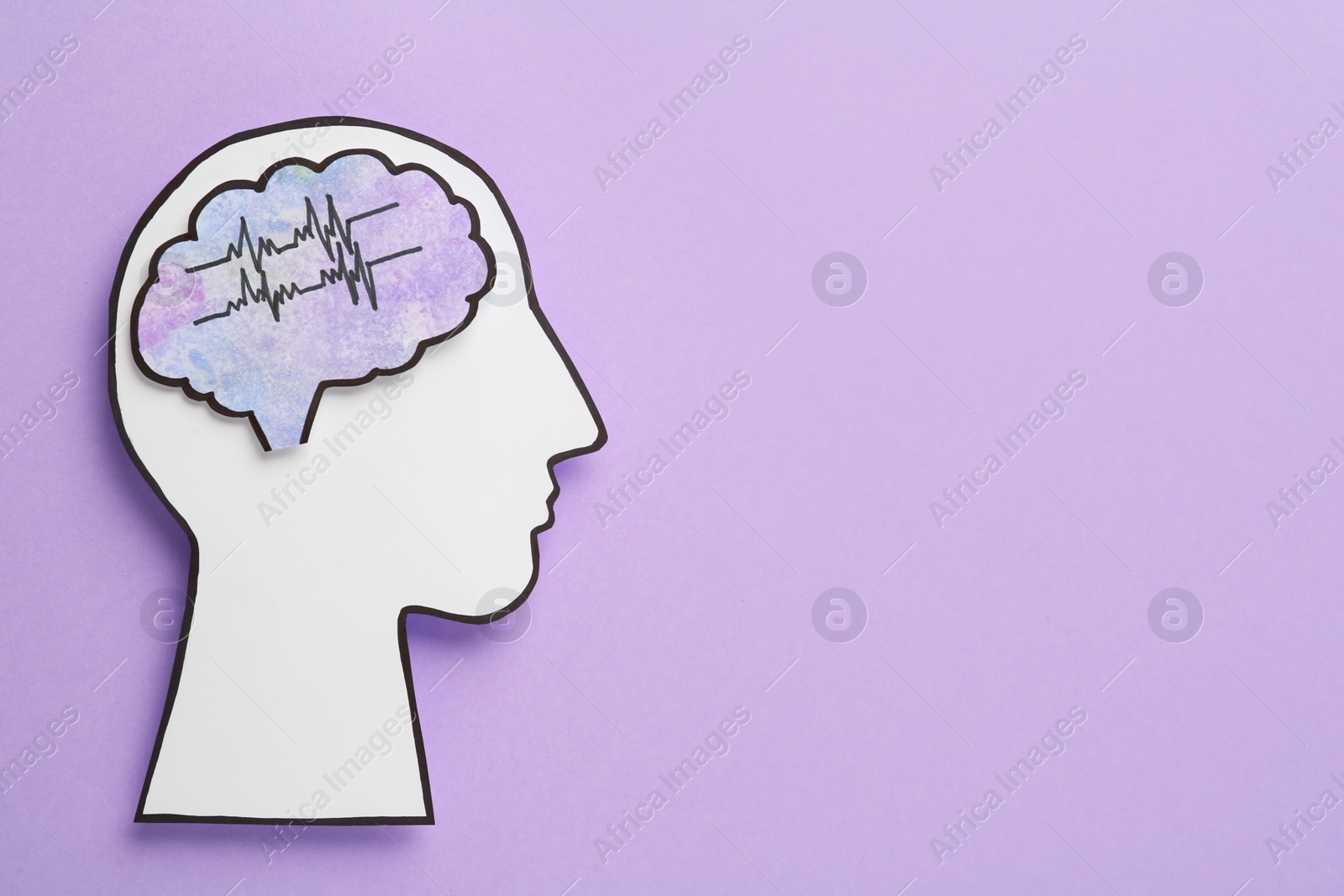 Photo of Top view of human head cutout with brain on violet background, space for text. Epilepsy awareness