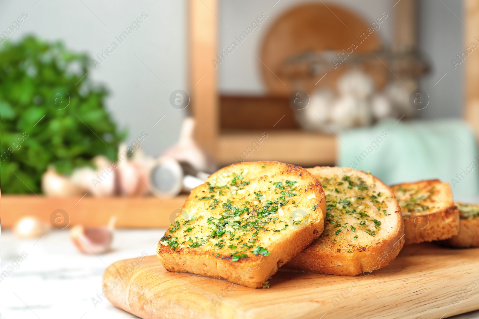 Photo of Slices of toasted bread with garlic and herbs on table. Space for text