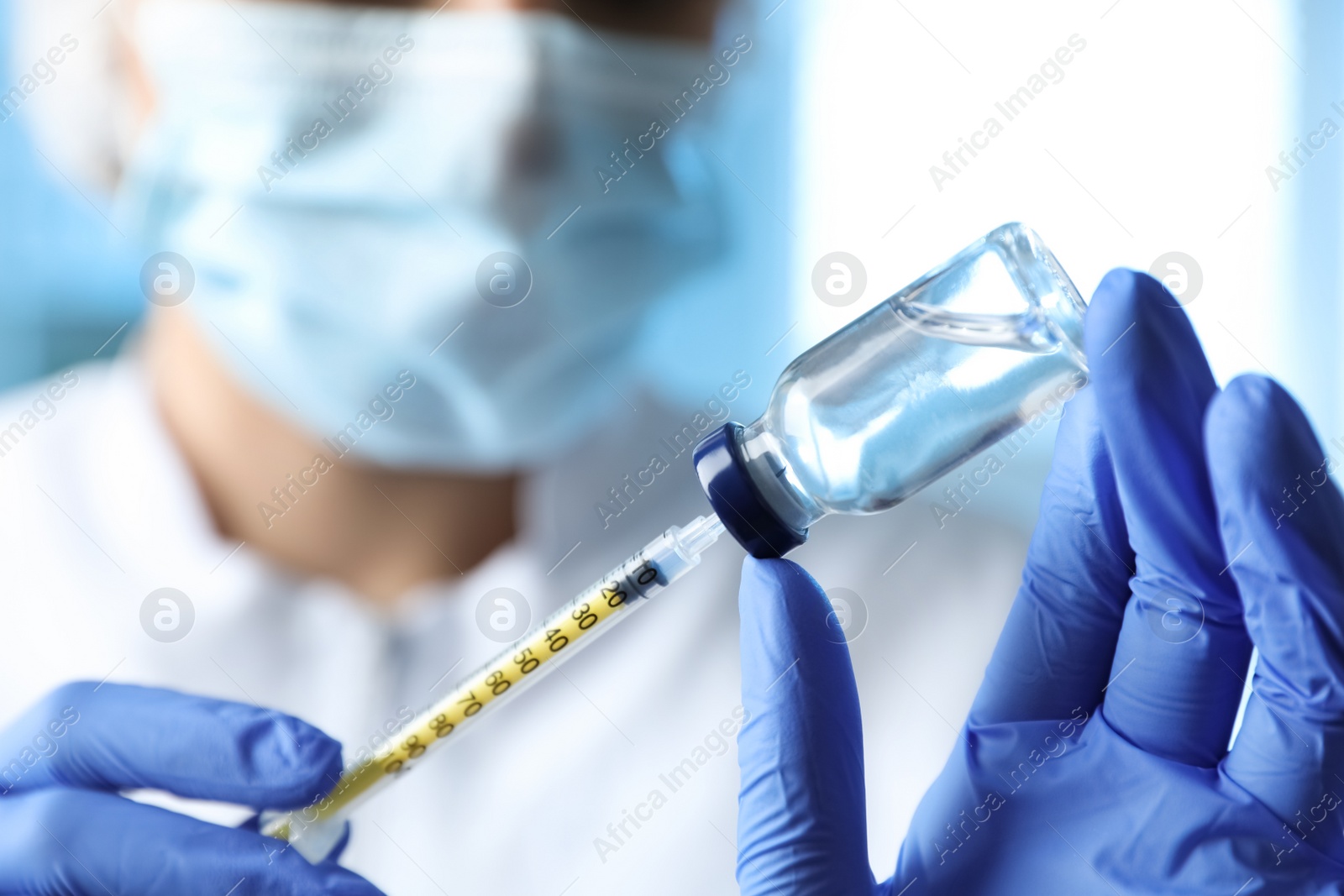 Photo of Doctor filling syringe with medication in clinic, closeup. Vaccination and immunization