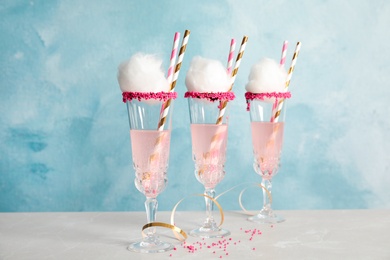 Photo of Cocktail with cotton candy in glasses on table