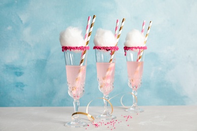 Cocktail with cotton candy in glasses on table