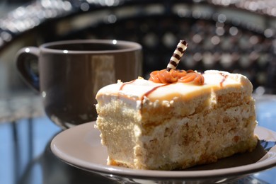 Photo of Tasty dessert and cup of fresh aromatic coffee on glass table outdoors, closeup