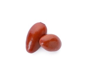 Two ripe red dates on white background, top view