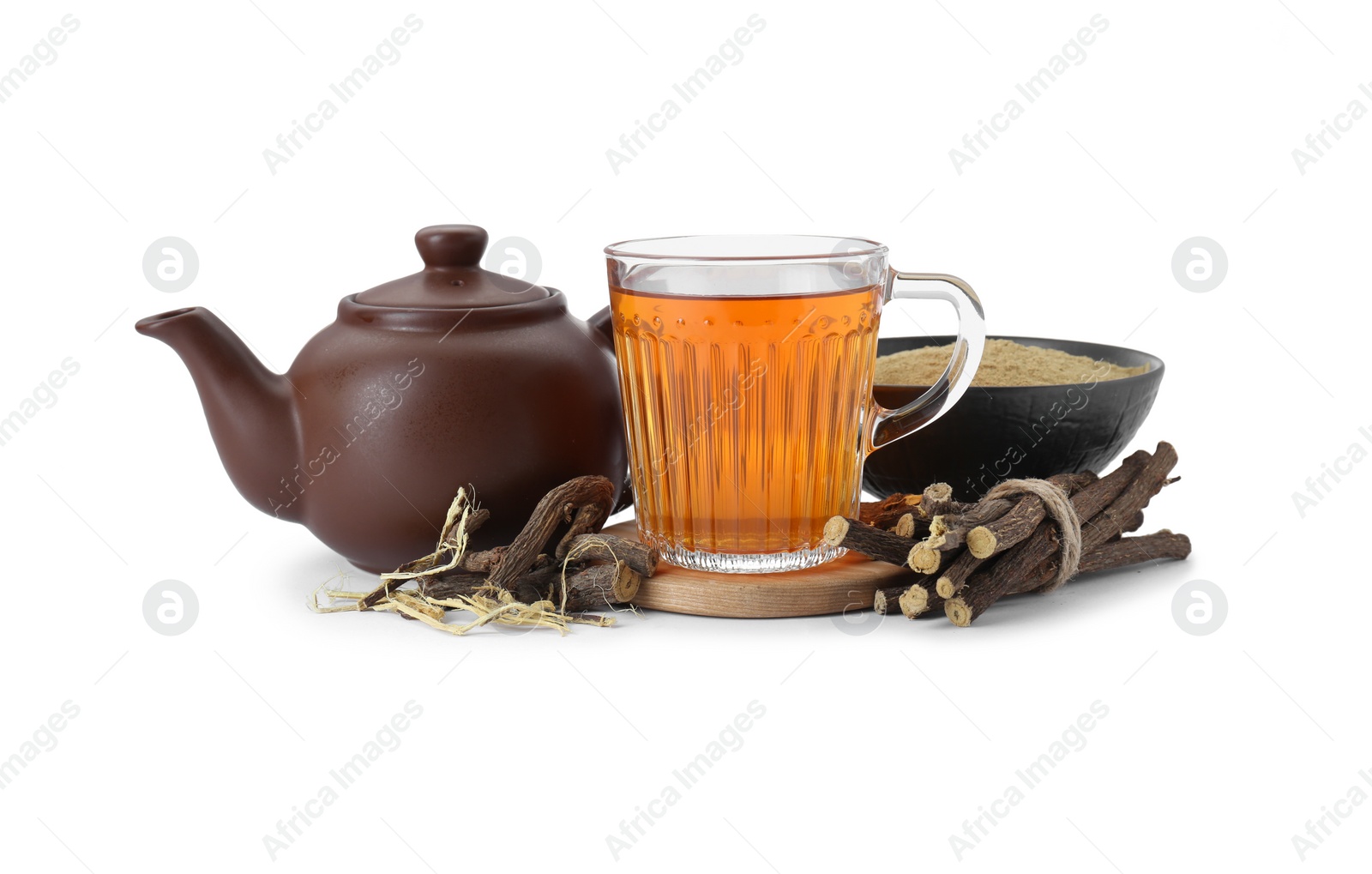 Photo of Aromatic licorice tea in cup, teapot, dried sticks of licorice root and powder isolated on white