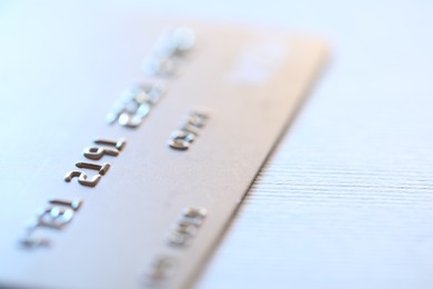 Photo of One credit card on light background, macro view. Space for text