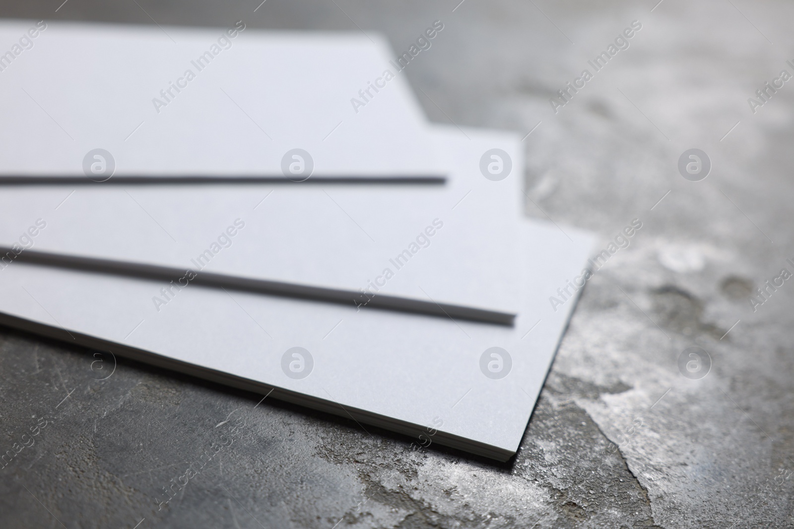 Photo of Blank business cards on grey textured background, closeup. Mockup for design