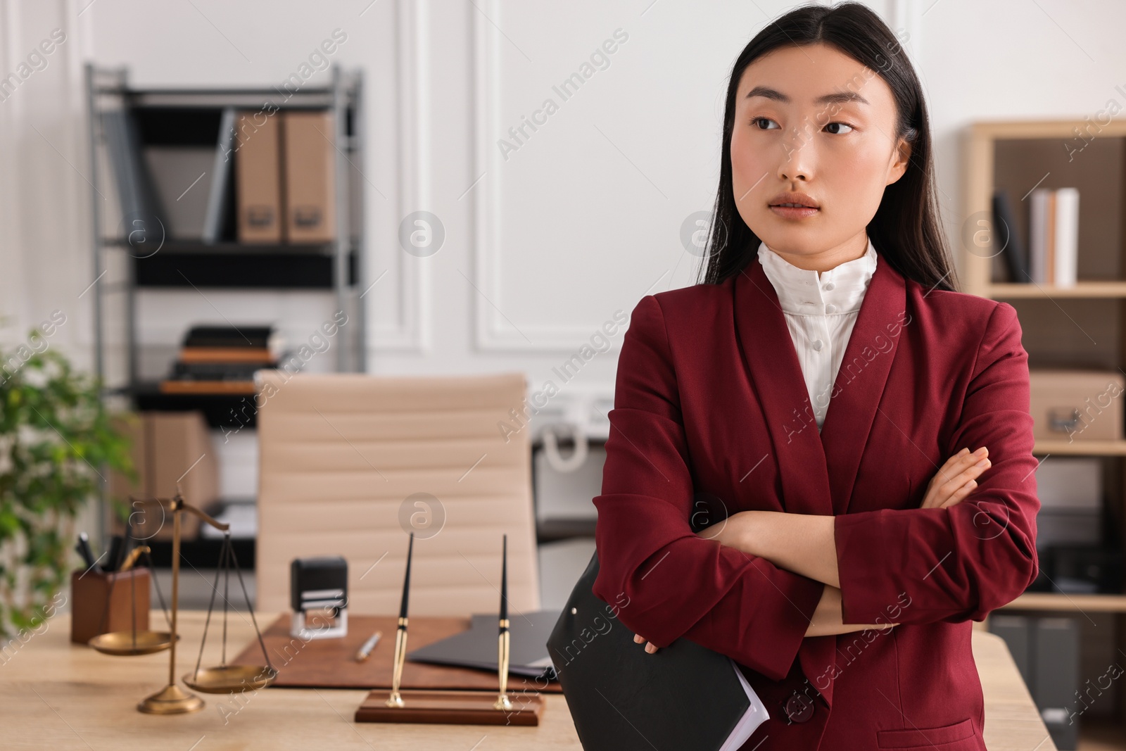 Photo of Portrait of notary with crossed arms in office. Space for text