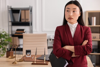 Portrait of notary with crossed arms in office. Space for text