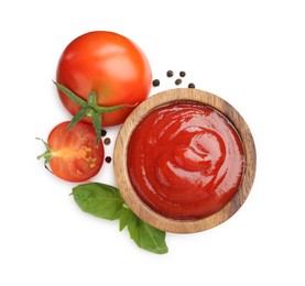 Photo of Tasty ketchup in wooden bowl, fresh tomatoes, peppercorns and basil isolated on white, top view