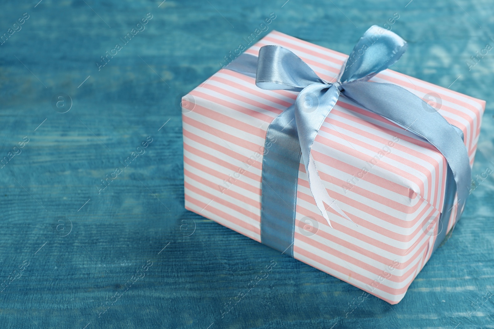 Photo of Elegant gift box with bow on wooden background