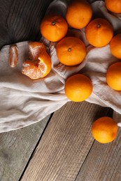 Photo of Tasty fresh tangerines on wooden table, above view. Space for text
