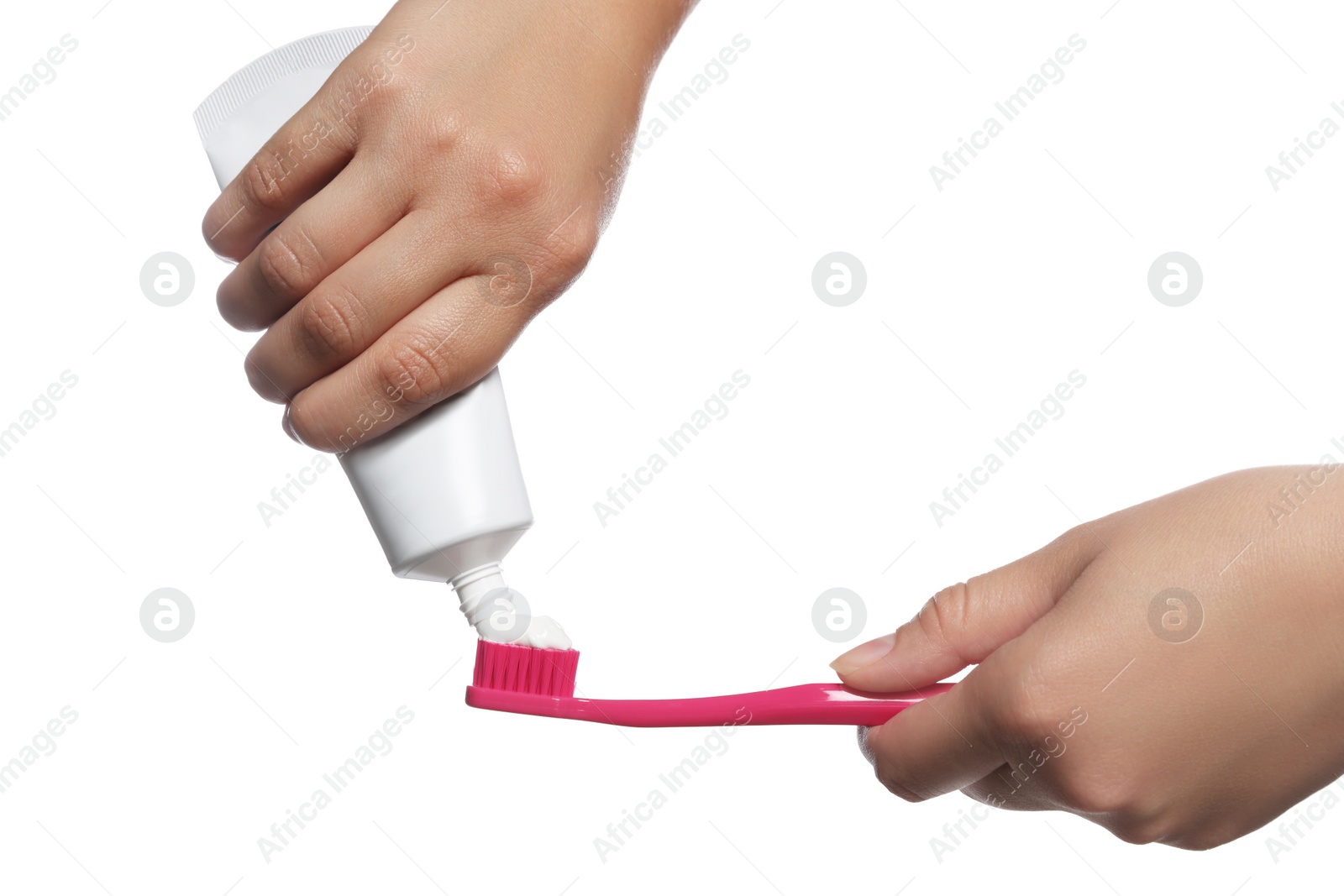 Photo of Woman applying toothpaste on brush against white background, closeup