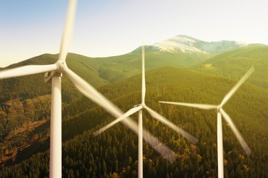 Image of Modern wind turbines in mountains. Alternative energy source